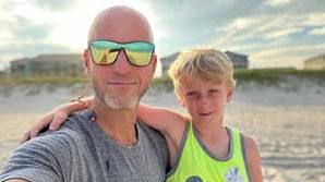Ryan Wagner with his son on the beach.