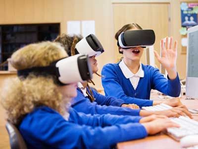 Young students using virtual reality headsets.