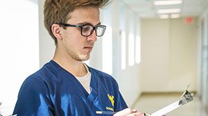 Male nursing student filling out a form.