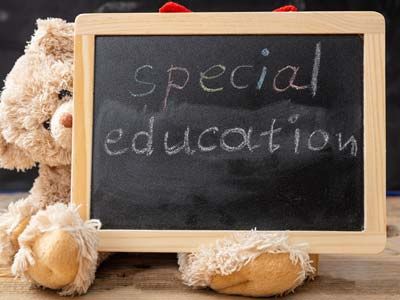 Teddy bear holding a chalkboard that reads "Special Education."