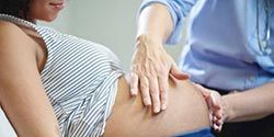 Pregnant woman getting examined.