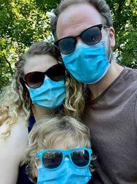 Gary with his family, wearing masks.