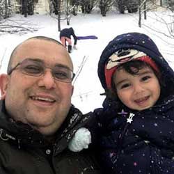 Al-Shebeeb in the snow with his son.
