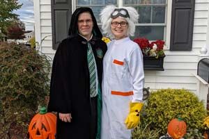 Pam E. McDonald dressed up for Halloween in front of her house with her husband.