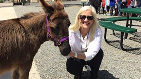 Jill posing with a donkey.