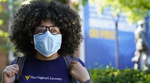 African American woman wearing a WVU t-shirt and mask.