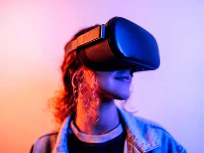 Neon portrait of young woman wearing virtual reality headset.