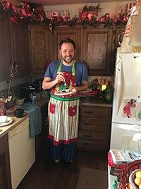 Gary wearing an apron in his kitchen.