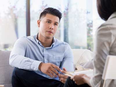 Young man talking to a rehabilitation counselor.