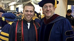 Chris at graduation with professor.