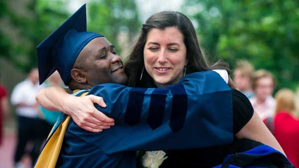 Two WVU graduates hugging at commencement.